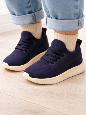 Navy colored sneakers with white sole from Puma